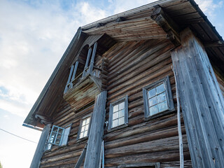 Facade of an old wooden Karelian house with a balcony