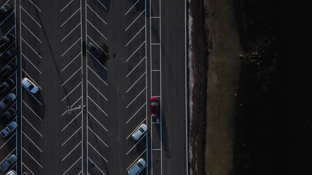 Aerial overhead view of newly paved half empty parking lot