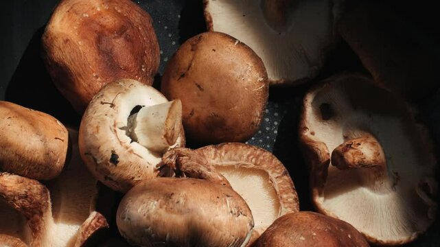 Fresh Royal oyster mushrooms, chef cooking on a wooden cutting board with knife in cafe asian restaurant kitchen, vibrant scene of food preparation
