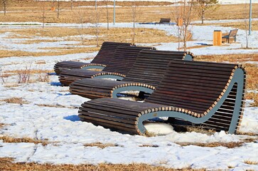 Benches of original shape in the winter park