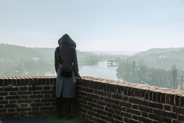 Woman overlooking Prague and Vltava River in winter