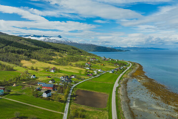 Mountain view near the city of Narvik in Norway. Spring, sun, greenery and snow-capped peaks.