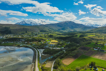 Mountain view near the city of Narvik in Norway. Spring, sun, greenery and snow-capped peaks.