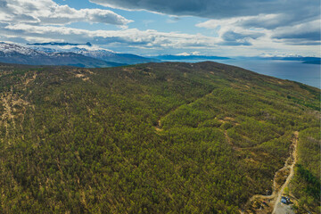 Mountain view near the city of Narvik in Norway. Spring, sun, greenery and snow-capped peaks.