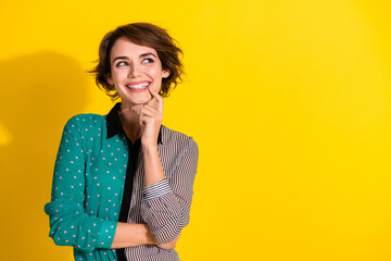 Photo of minded lovely girl wear trendy dotted print clothes look empty space isolated on yellow...