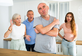 Obraz premium Portrait of a thoughtful man who had a conflict with his wife and parents while cooking dinner in the kitchen
