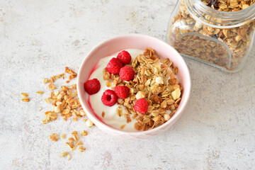 Delicious Granola and Yogurt Breakfast with Fresh Raspberries table top view