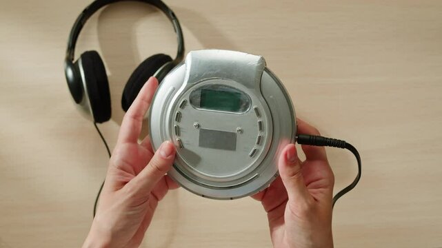 CD Player, Using headphone for old music portable compact player close-up. Listen to music with vintage player. 