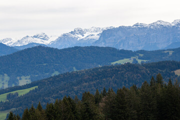 Breathtaking panoramic view from the Pfänder mountain in showcasing the majestic snow-capped Alps stretching across the horizon
