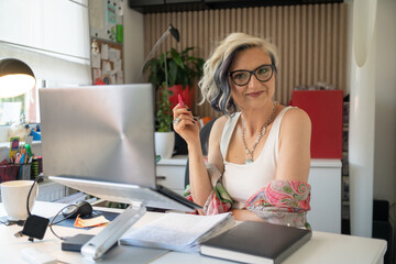 A successful businesswoman entrepreneur in her home office  