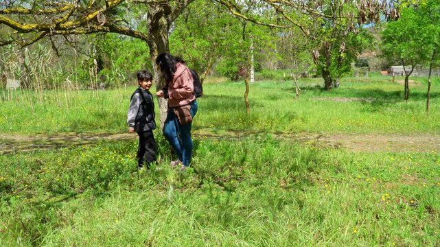 Mother and son learning about nature on the countryside during educational vacations