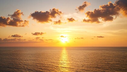 Fototapeta premium orange sunlight paints the morning sky over the ocean, reflecting on the water as waves gently touch the summer beach horizon