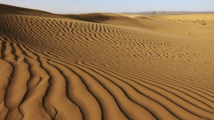 Sand blowing over sand dunes in wind