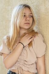 Naklejka premium Close-up portrait of young beautiful blonde girl outdoors.