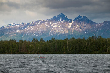 Sun on mountains behind Lake Lucille in Alaska