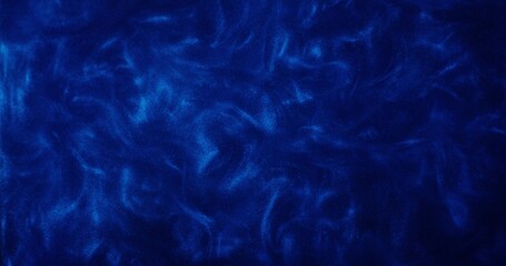 Abstract background. A dark blue liquid with sparkles shimmers and boils