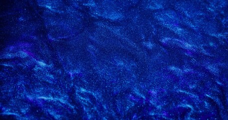 Abstract background. The blue paint with sparkles is bubbling and shimmering