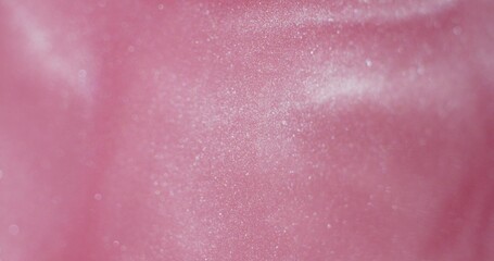 Abstract background. Pink glitter paint shimmers