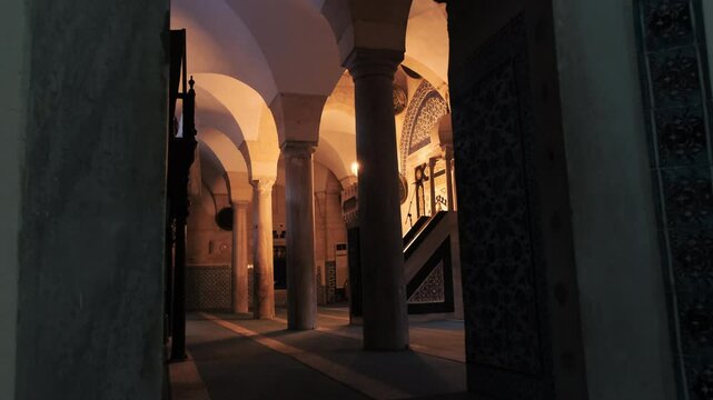 Dimly lit columned and arched corridors reflecting the atmosphere of Adana Ulu Mosque. Feel the peaceful and mystical atmosphere of the structure bearing Seljuk and Mamluk influences.