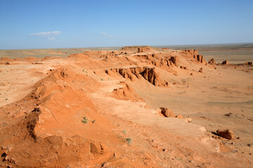 Panorama of the red earth of Bayanzag flaming cliffs, aka dinosaur cemetery, Gobi Desert, Mongolia