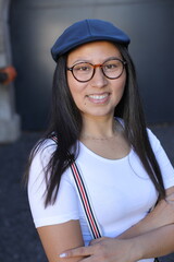 Woman wearing suspenders and a vintage hat 