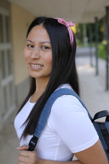 Pretty Latina woman holding a backpack