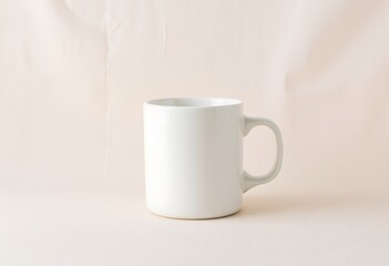 Fototapeta premium A plain white ceramic mug on a light-colored surface, perfect for branding.