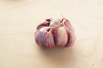 Raw garlic on the wooden table background, close-up. Organic garlic for publication, poster, screensaver, wallpaper, postcard, banner, cover, post. Food cook rustic still