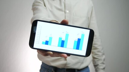 Close-up of male analyst or businessman hands showing graph with statistics or analytics on phone. Concept - forecasts, analytics, business forecasts, statistics. - Powered by Adobe