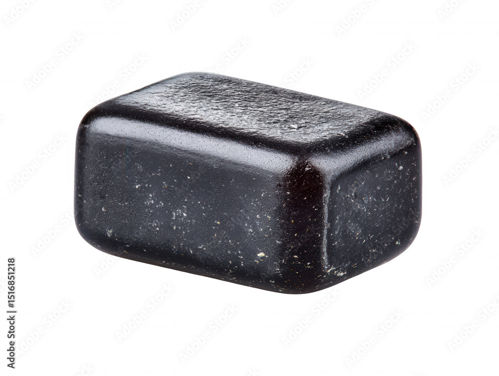 Poster the smooth, rounded rectangle of dark charcoal gray rock sits on a stark white surface, showing slig