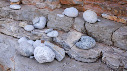 balanced stones stack cairn close up on sea beach.