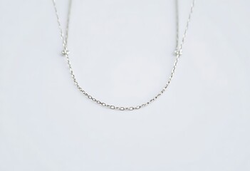 silver necklace with three balls hanging from it