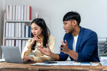 Diverse Professionals Collaborating on Laptop