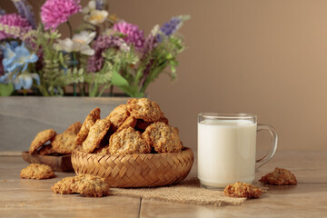 Oatmeal cookies and milk sit on a kitchen table.