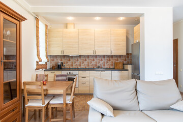 Modern Home Kitchen and Living Area With Wooden Furniture and Neutral Decor