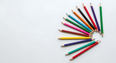 Colorful pencils arranged in a spiral on a white background  