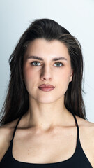 Obraz premium Portrait of confident young woman with long dark hair and brown eyes