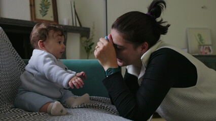 Mother holding object to engage baby, encouraging sensory exploration and focus, nurturing playtime...
