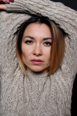 Portrait of beautiful red haired female in grey melange sweater