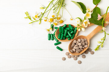Alternative medicine herbal capsule organic drug on wooden background.Assortment of herbal and...