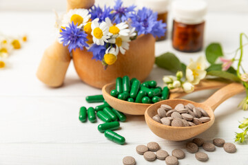 Alternative medicine herbal capsule organic drug on wooden background.Assortment of herbal and tablets,vitamins and dietary supplements.medicinal and Healing herbs.natural supplements for healthy life