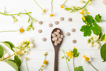 Alternative medicine herbal capsule organic drug on wooden background.Assortment of herbal and...