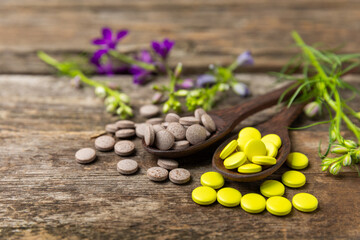 Alternative medicine herbal capsule organic drug on wooden background.Assortment of herbal and...
