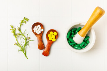 Alternative medicine herbal capsule organic drug on wooden background.Assortment of herbal and...