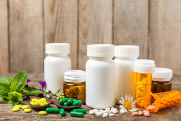 Alternative medicine herbal capsule organic drug on wooden background.Assortment of herbal and...