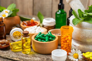 Alternative medicine herbal capsule organic drug on wooden background.Assortment of herbal and...