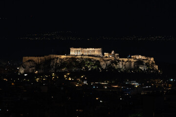 Photo of the Acropolis of Athens illuminated during nighttime.