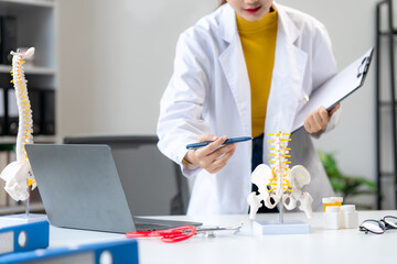 Doctor Explaining Spinal Anatomy with Model