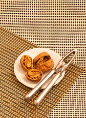 nuts and nutcracker on a plate