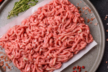 Raw ground beef or pork as an ingredient for burgers. Raw minced meat